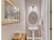 Charming powder room features a pedestal sink, neutral walls, and decorative accents at 1038 Branwell Dr, Durham, NC 27703