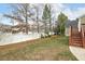 View of the home's backyard with a white fence and partially covered in dormant grass at 104 Low Country Ct, Morrisville, NC 27560
