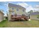 Spacious backyard view featuring a wooden deck, green lawn, and the home's exterior at 104 Low Country Ct, Morrisville, NC 27560