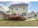 Rear view of home showing its spacious backyard and deck leading to a well manicured lawn at 104 Low Country Ct, Morrisville, NC 27560