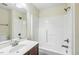 Bright bathroom featuring a single vanity, tiled shower with a tub, and neutral wall color at 104 Low Country Ct, Morrisville, NC 27560