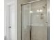 Modern bathroom featuring a glass-enclosed shower with sleek fixtures and marble-like tiling at 104 Low Country Ct, Morrisville, NC 27560