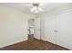 Well-lit bedroom with hardwood floors, closet and an open doorway view to a staircase at 104 Low Country Ct, Morrisville, NC 27560