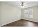 Bright, empty bedroom with modern flooring, white trim, a ceiling fan, and a window at 104 Low Country Ct, Morrisville, NC 27560