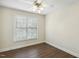 Cozy bedroom featuring a ceiling fan and a bright window at 104 Low Country Ct, Morrisville, NC 27560