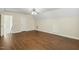 Well-lit bonus room with hardwood floors, neutral walls, and a modern ceiling fan fixture at 104 Low Country Ct, Morrisville, NC 27560