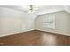 Bonus room showcasing hardwood floors, natural light, and neutral walls with a modern ceiling fan at 104 Low Country Ct, Morrisville, NC 27560