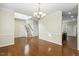 Spacious dining room with hardwood floors, a chandelier, and access to staircase and kitchen at 104 Low Country Ct, Morrisville, NC 27560