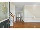 Bright foyer featuring hardwood floors, a staircase, and a decorative glass front door at 104 Low Country Ct, Morrisville, NC 27560