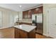 Well-equipped kitchen boasts an island, stainless steel appliances, and ample cabinet space at 104 Low Country Ct, Morrisville, NC 27560