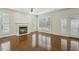 Comfortable living room features a fireplace, hardwood floors, and lots of natural light at 104 Low Country Ct, Morrisville, NC 27560
