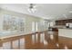 Spacious living room with hardwood floors, large windows, and direct access to the kitchen area at 104 Low Country Ct, Morrisville, NC 27560