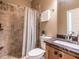 Bathroom features a tiled shower, wood vanity, and granite countertop at 107 Bella Casa Way, Clayton, NC 27527