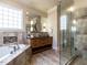 Modern bathroom with double sink vanity, soaking tub, and glass shower at 107 Bella Casa Way, Clayton, NC 27527