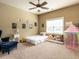 Charming bedroom with plush carpet, ceiling fan, and bright natural light from the window at 107 Bella Casa Way, Clayton, NC 27527