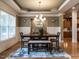 Bright dining room with a modern table set, chandelier, and decorative wall details at 107 Bella Casa Way, Clayton, NC 27527