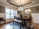 Comfortable dining area featuring stylish decor, a large window, and chandelier lighting at 107 Bella Casa Way, Clayton, NC 27527