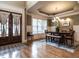 Elegant dining room with hardwood floors, modern chandelier and large windows at 107 Bella Casa Way, Clayton, NC 27527