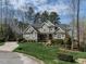 Stylish home with a manicured lawn and detailed landscaping around the front entrance at 107 Bella Casa Way, Clayton, NC 27527