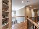Upstairs hallway with hardwood floors, built-in shelving, and lots of natural light at 107 Bella Casa Way, Clayton, NC 27527