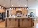 Chef's kitchen features custom cabinetry, stainless steel appliances, and large island at 107 Bella Casa Way, Clayton, NC 27527