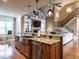 Open kitchen with granite countertops, stainless steel appliances, and views of the living area at 107 Bella Casa Way, Clayton, NC 27527
