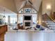 Vaulted ceiling living room with fireplace, large sofa, and seamless open floorplan at 107 Bella Casa Way, Clayton, NC 27527