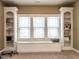 Bright living room has custom shelving and a window seat with storage at 107 Bella Casa Way, Clayton, NC 27527