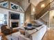 Bright living room features a cozy fireplace, large sectional sofa, and hardwood flooring at 107 Bella Casa Way, Clayton, NC 27527