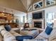 Spacious living room with a stone fireplace, large sectional sofa, and hardwood floors at 107 Bella Casa Way, Clayton, NC 27527