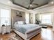 This beautiful main bedroom features a large bed, tray ceiling, and built-in shelves at 107 Bella Casa Way, Clayton, NC 27527