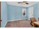 Bright bedroom featuring a neutral carpet, chair, and window offering natural light at 108 Birdie Ct, Rocky Mount, NC 27804