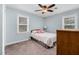 Serene bedroom boasts carpet floors, a ceiling fan with light, and a large window for ample natural light at 108 Birdie Ct, Rocky Mount, NC 27804