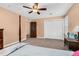 Bedroom with carpet flooring, four post bed, ceiling fan with lights, and a closet with white bi-fold doors at 108 Birdie Ct, Rocky Mount, NC 27804