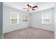 Cozy bedroom with carpet, fan, and bright windows at 108 Birdie Ct, Rocky Mount, NC 27804