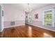 Classic dining room featuring light pink walls, hardwood floors, and elegant chandelier at 108 Birdie Ct, Rocky Mount, NC 27804