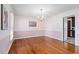 Bright dining room with light walls, hardwood floors, chandelier, and view into the kitchen at 108 Birdie Ct, Rocky Mount, NC 27804