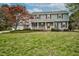 Inviting two-story home features a charming front porch, red shutters, and a spacious lawn perfect for outdoor enjoyment at 108 Birdie Ct, Rocky Mount, NC 27804