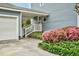 Charming home exterior with light blue siding, white trim, and a beautiful front yard garden at 108 Birdie Ct, Rocky Mount, NC 27804