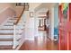 Elegant foyer featuring hardwood floors, staircase with white railing, and view into the living area at 108 Birdie Ct, Rocky Mount, NC 27804