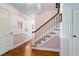 Bright foyer with hardwood floors, stairs with a white railing, and freshly painted walls at 108 Birdie Ct, Rocky Mount, NC 27804