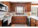 Close-up of the kitchen featuring wood cabinets, neutral countertops, and stainless steel appliances at 108 Birdie Ct, Rocky Mount, NC 27804
