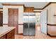 This kitchen features tile flooring, wood cabinets and stainless steel fridge at 108 Birdie Ct, Rocky Mount, NC 27804