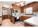 This updated kitchen features stainless steel appliances, wooden cabinets and tile flooring at 108 Birdie Ct, Rocky Mount, NC 27804