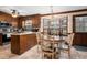 Cozy kitchen featuring wood cabinets, a breakfast nook, and a view of the backyard through bay windows at 108 Birdie Ct, Rocky Mount, NC 27804