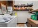 Functional laundry room with a washer, dryer, storage shelves, and a laundry sink at 108 Birdie Ct, Rocky Mount, NC 27804