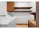 Laundry area with white washer and dryer, storage cabinet, and wood trim at 108 Birdie Ct, Rocky Mount, NC 27804