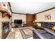 Inviting living room featuring brick fireplace, a TV, and leather sofas at 108 Birdie Ct, Rocky Mount, NC 27804
