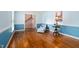 Cozy living room featuring wainscoting, hardwood floors, and comfortable seating by the window at 108 Birdie Ct, Rocky Mount, NC 27804