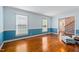 Bright, open living room with hardwood floors, wainscoting, and a view into the entry foyer at 108 Birdie Ct, Rocky Mount, NC 27804